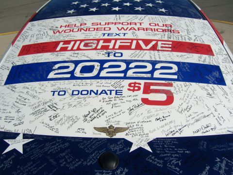 2007 Ford Mustang - Car roof decorated with American flag design and numerous signatures for a charity event.