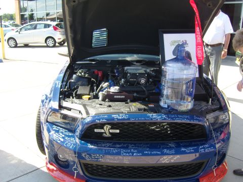 2007 Ford Mustang - This blue Ford Mustang has been signed by many people, with a framed picture and water jug placed on its engine.