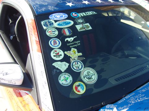 2007 Ford Mustang - A windshield is covered in numerous Mustang club stickers, with one clearly indicating the Northern Virginia Mustang Club.