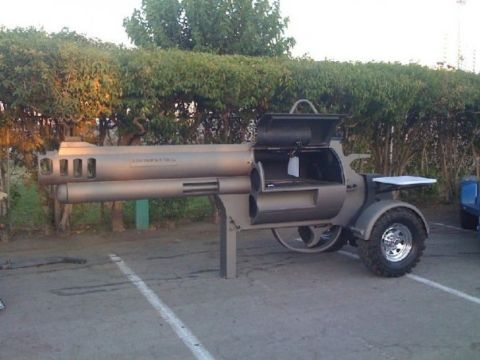 2006 Ford E350 - A custom-built grill shaped like a revolver is parked outdoors.