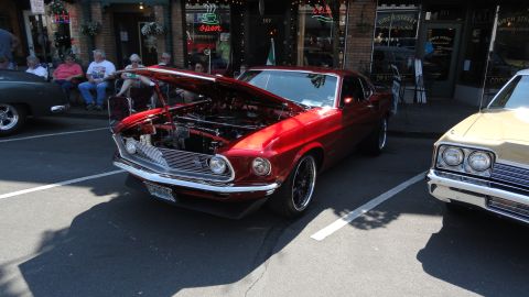 1964 Ford Fairlane - A red 1969 coupe is displayed with its hood open, parked alongside another vehicle on a sunny day.