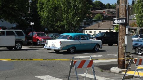 1964 Ford Fairlane - A two-tone blue and white 1956 sedan is seen from the rear, driving in traffic.