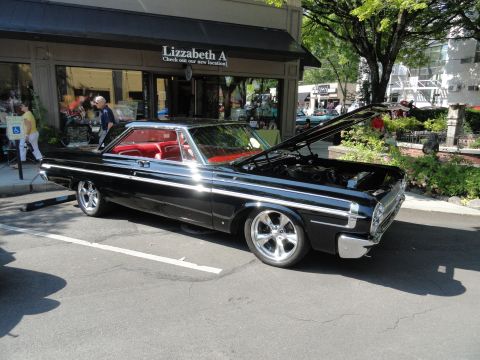 1964 Ford Fairlane - Black 1964 Ford Fairlane coupe with red interior parked on street, hood up.