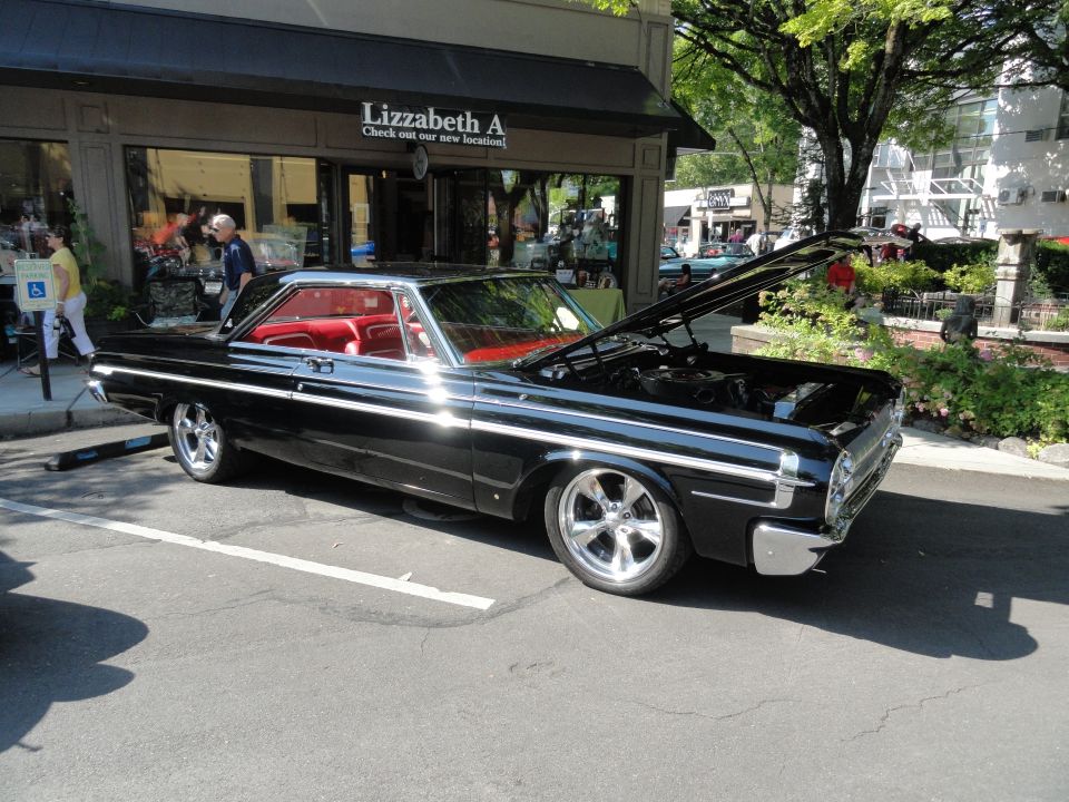 1964 Ford Fairlane coupe, black exterior, red interior, hood open showing engine