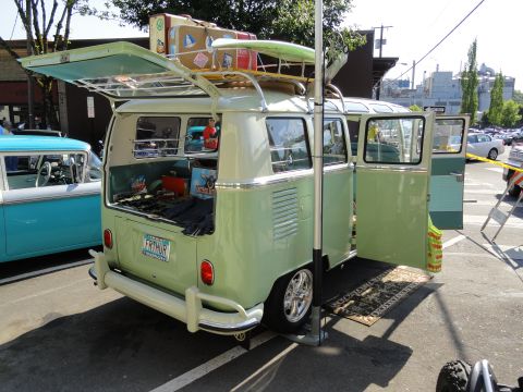 1964 Ford Fairlane - A vintage Volkswagen bus is packed for a trip, with luggage and a surfboard on the roof and the interior visible.