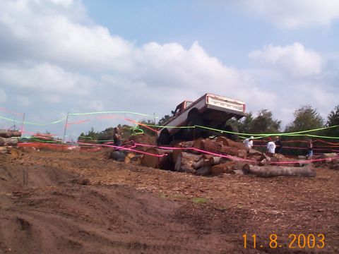 1992 Ford Bronco - A Ford F-Series truck navigates an obstacle course made of logs.