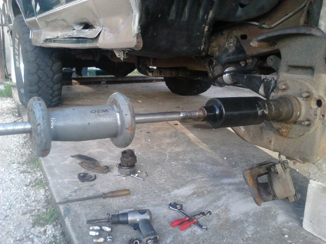 Take off the 5 or 6 spindle nuts. to make everything easier i used a slide hammer and spindle puller setup. 3 hits had the spindle off in less than 10 seconds and no damage to anything

I had 4WABS on this truck but from a previous time taking the spindle off, i already had the sensor off (nottice the hole). Getting the sensor off is a PITA. if i remeber it uses a 12-point 6mm or 5.5mm bolt, not sure. Either way the bolt never comes out and almost always has to be broken off. I never likes ABS so i never bothered spending the money to get it fixed. Taking out this sensor will make the ABS light come on and no longerwork.