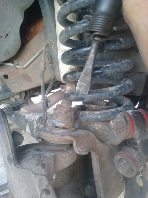 1996 Ford Bronco - Take the alignment bushing out. this can be tricky sometimes. I use a hammer and hit the balljoint stud down till it breaks free. this lets…