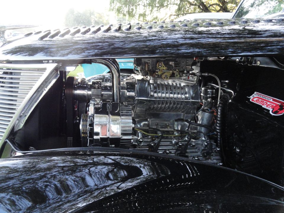 Chrome supercharger and engine components on a black car
