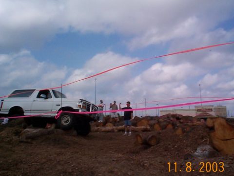 1992 Ford Bronco - A white 1992 Ford Bronco is seen on an obstacle course, with pink ribbons strung across the sky.