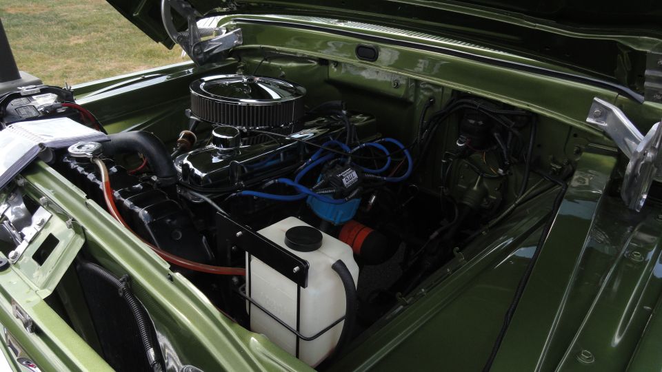 green engine bay with chrome air cleaner and blue spark plug wires