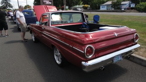 1964 Ford Fairlane - This 1964 Ford Falcon Ranchero features a deep red paint job, chrome accents, and aftermarket wheels, seen at a car show.
