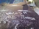 1988 Ford Bronco - Graffiti on a surface reads 'WASH ME please'.