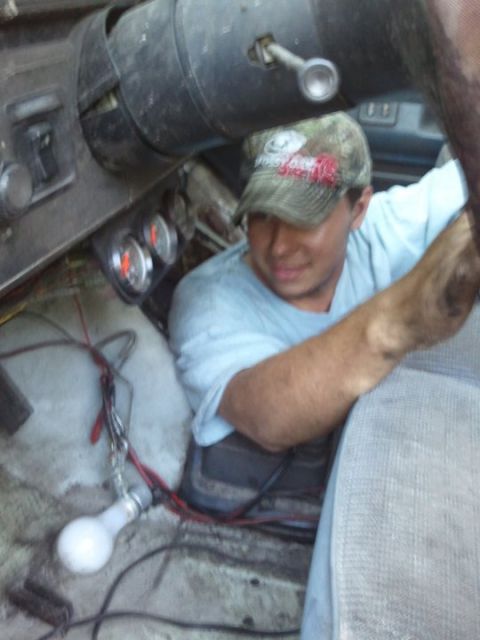 1988 Ford Bronco - Person working on wiring inside the interior of a 1988 Ford Bronco.