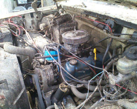 1988 Ford Bronco - The engine bay is filled with various hoses, wires, and engine components, with a Supermotors.net logo in the lower right corner.