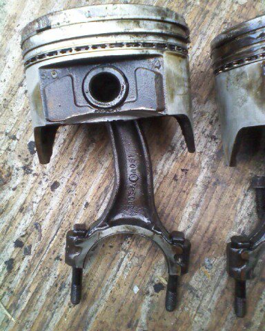 1988 Ford Bronco - Close-up of engine pistons and connecting rods, showing internal engine components.