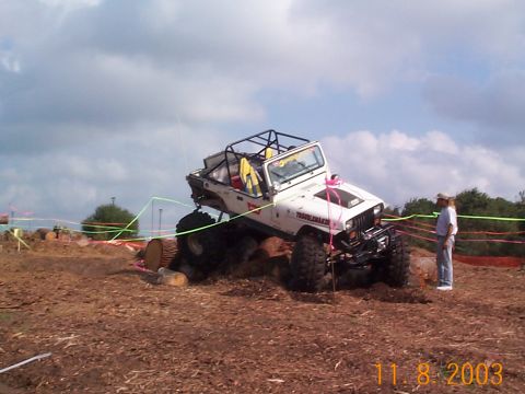 1992 Ford Bronco - Modified Jeep Wrangler navigating an obstacle course with logs.