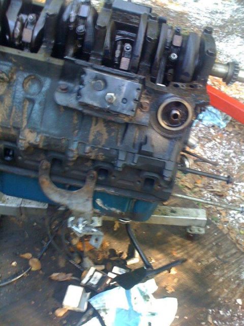 1988 Ford Bronco - The internal components of an engine block are visible, resting on a stand outdoors.