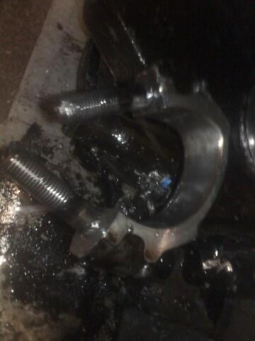 1988 Ford Bronco - Greasy metal part with threaded bolts, likely from a vehicle's drivetrain.