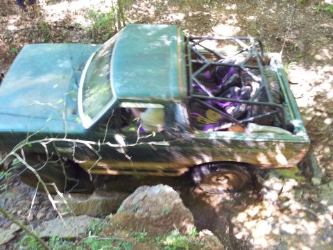 2012 Ford Bronco - This off-road vehicle navigates a challenging rocky and muddy terrain.