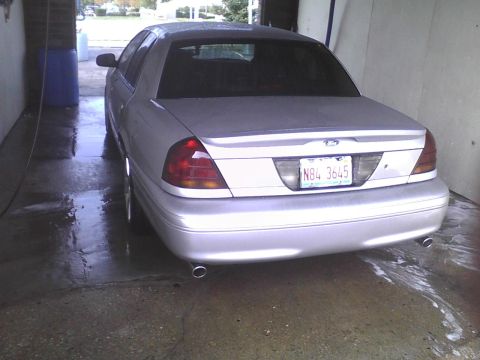 2003 Ford Crown Victoria - Rear view of a 2003 Ford Crown Victoria parked inside a car wash bay.