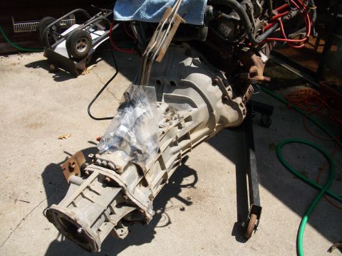 1995 Ford Bronco - Transmission and engine parts are shown disassembled and mounted on a stand.