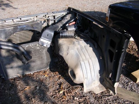 1988 Ford Bronco - The front clip of a 1988 Ford Bronco has been removed, exposing the radiator and inner fender assembly.