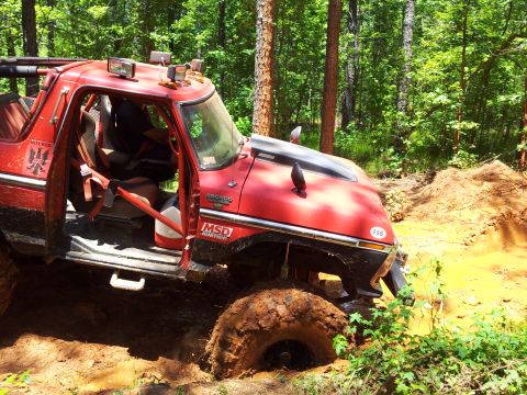 2012 Ford Bronco - Off-road vehicle stuck deep in mud during an outdoor excursion.