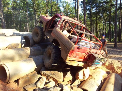 Ford Bronco - This heavily modified off-road vehicle navigates a challenging obstacle course made of concrete pipes and rocks.
