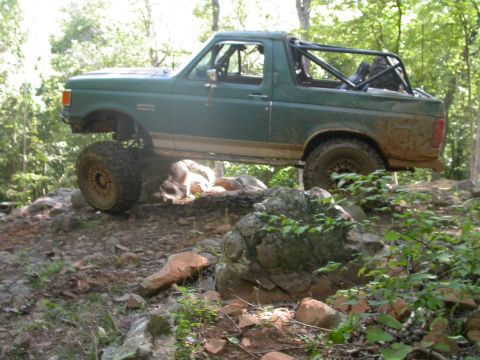 1990 Ford Bronco - This modified Ford Bronco navigates a rocky off-road course, its suspension and tire capabilities.