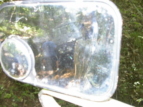 1990 Ford Bronco - Reflection in the side mirror shows the interior of a 1990 Ford Bronco with a person inside.