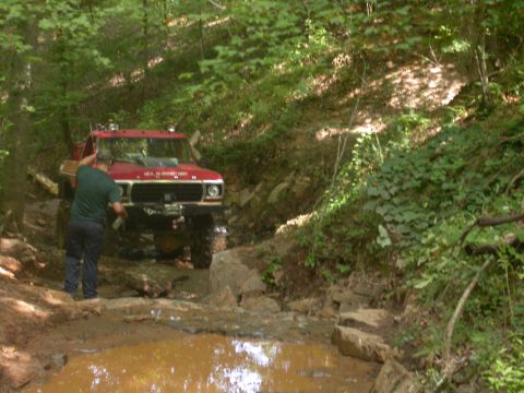 1990 Ford Bronco - This modified 1978 Ford F-150 navigates a muddy trail with a winch and auxiliary lighting visible.