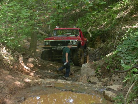 1990 Ford Bronco - Modified 1979 Ford F-Series truck tackling a challenging off-road course.