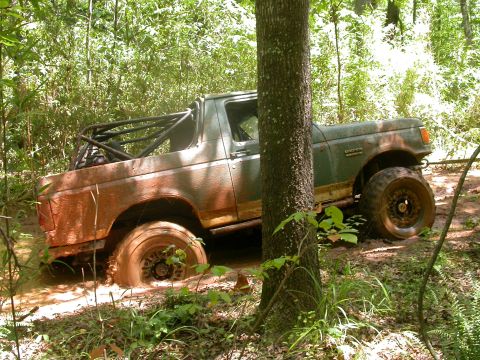 1990 Ford Bronco - This 1990 Ford Bronco is deep in the mud on an off-road trail.