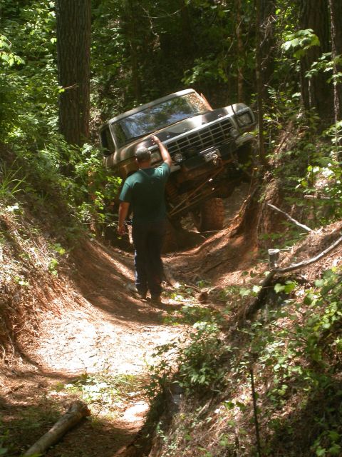 1990 Ford Bronco - Ford Bronco navigating a challenging off-road trail.