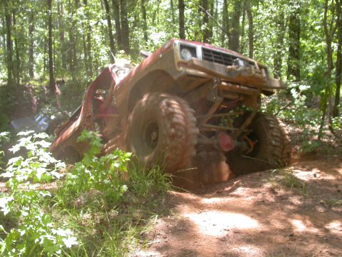 1990 Ford Bronco - This modified 1990 Ford Bronco appears to be stuck deep in the mud on a wooded trail.