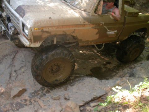 1990 Ford Bronco - This 1990 Ford Bronco navigates a challenging off-road course covered in mud.