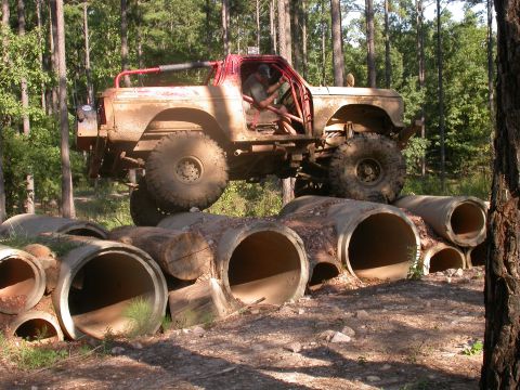 1990 Ford Bronco - This heavily modified 1990 Ford Bronco navigates an obstacle course of concrete pipes.