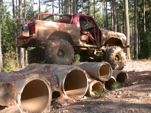 1990 Ford Bronco - Modified 1978 Ford Bronco navigating an obstacle course made of large concrete pipes.