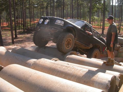 1990 Ford Bronco - This truck is navigating a challenging obstacle course made of concrete pipes.