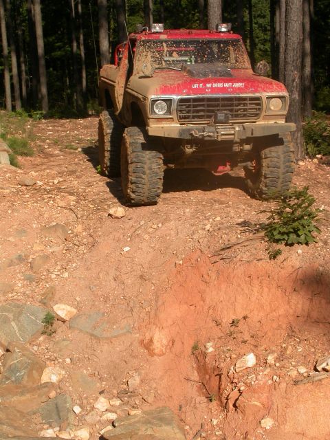 1990 Ford Bronco - This lifted 1979 Ford F-Series truck navigates a muddy off-road trail.