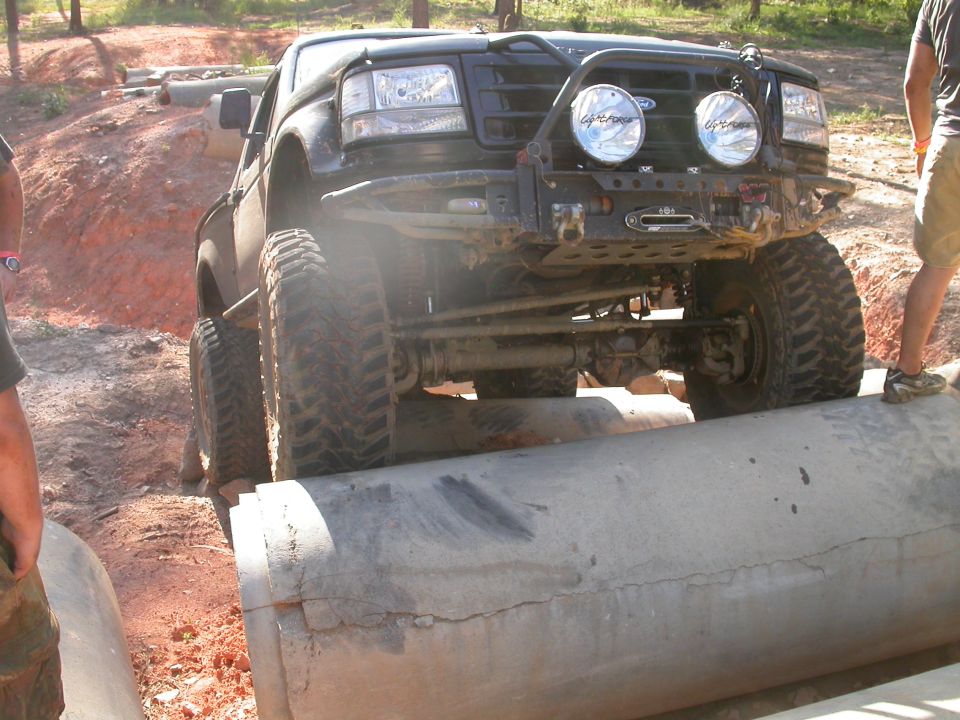 Black Ford Bronco with off-road tires and winch on concrete obstacle