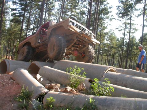 1990 Ford Bronco - Modified 1990 Ford Bronco navigating a challenging obstacle course made of concrete pipes.