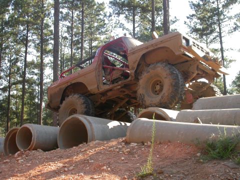 1990 Ford Bronco - This heavily modified truck navigates a challenging obstacle course made of large concrete pipes.