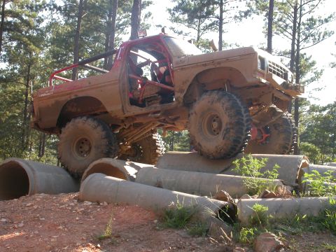 1990 Ford Bronco - This heavily modified off-road vehicle navigates a challenging obstacle course.