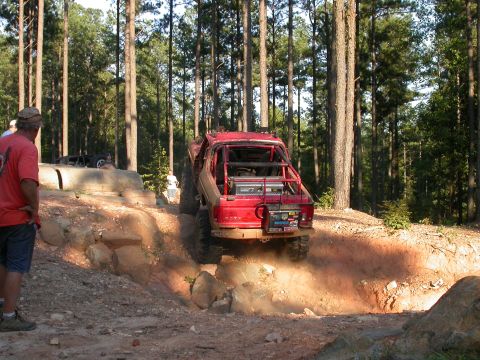 1990 Ford Bronco - Modified 1990 Ford Bronco tackling a challenging off-road trail.