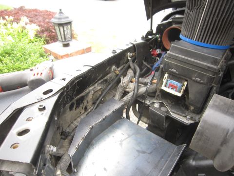2008 Jeep Wrangler - Close-up view of a vehicle's engine bay, showing an air filter, fuse box, and various electrical components.