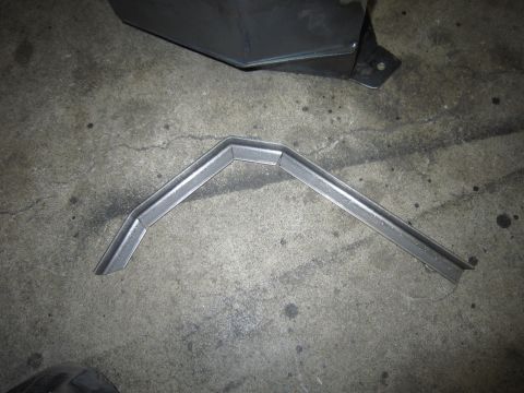 2008 Jeep Wrangler - A custom metal bracket lies on a concrete surface, possibly for a vehicle modification.