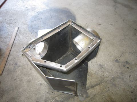 2008 Jeep Wrangler - A custom metal part, likely for an engine or exhaust system, is shown on a workshop floor.