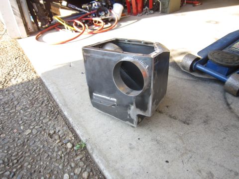 2008 Jeep Wrangler - A custom metal intake box sits on a concrete surface next to a blue hydraulic jack.
